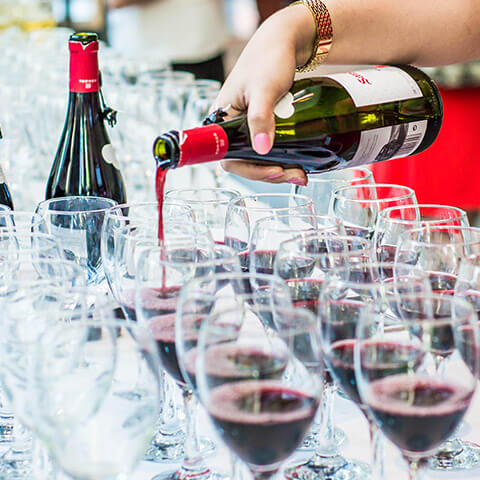 Wine being poured into wine glasses